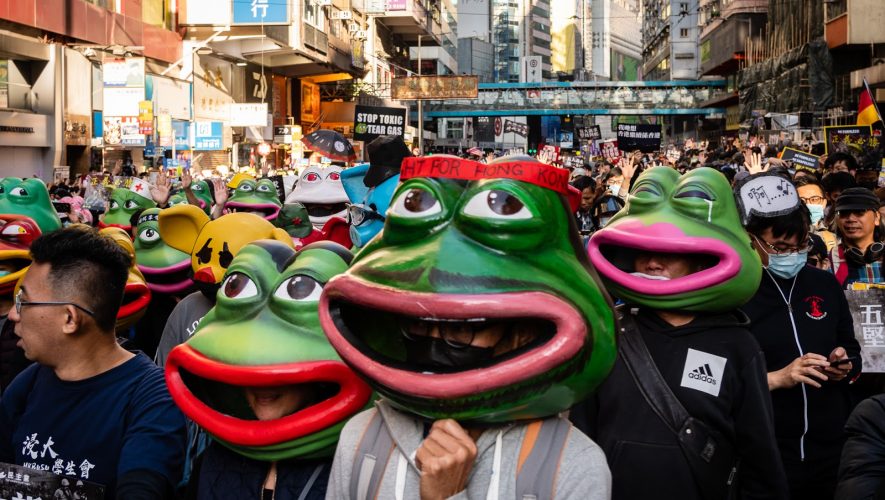 Pro-Democracy demonstrators in Hong Kong wear masks depicting Pepe the Frog.